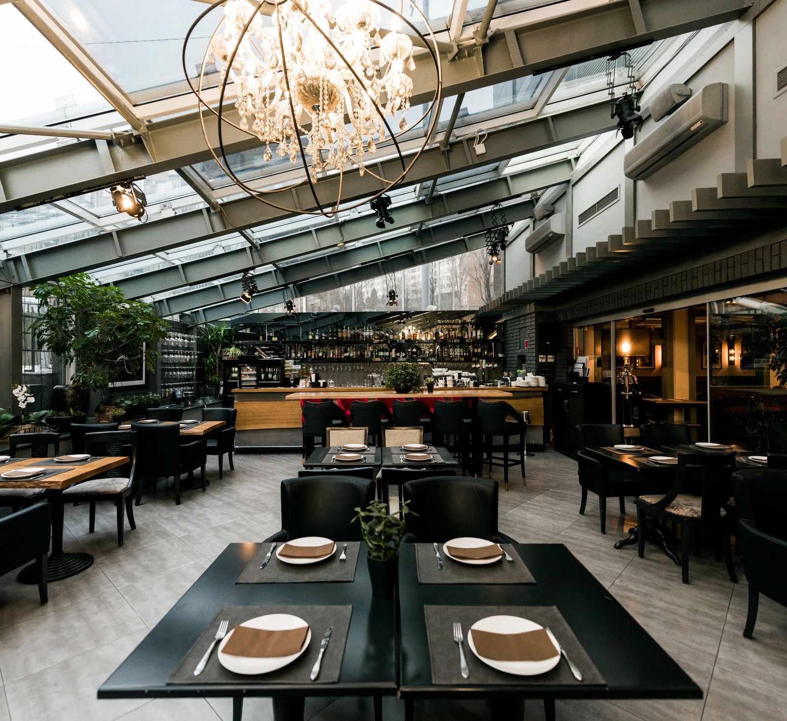 Bright restaurant dining room with a bar and chandelier
