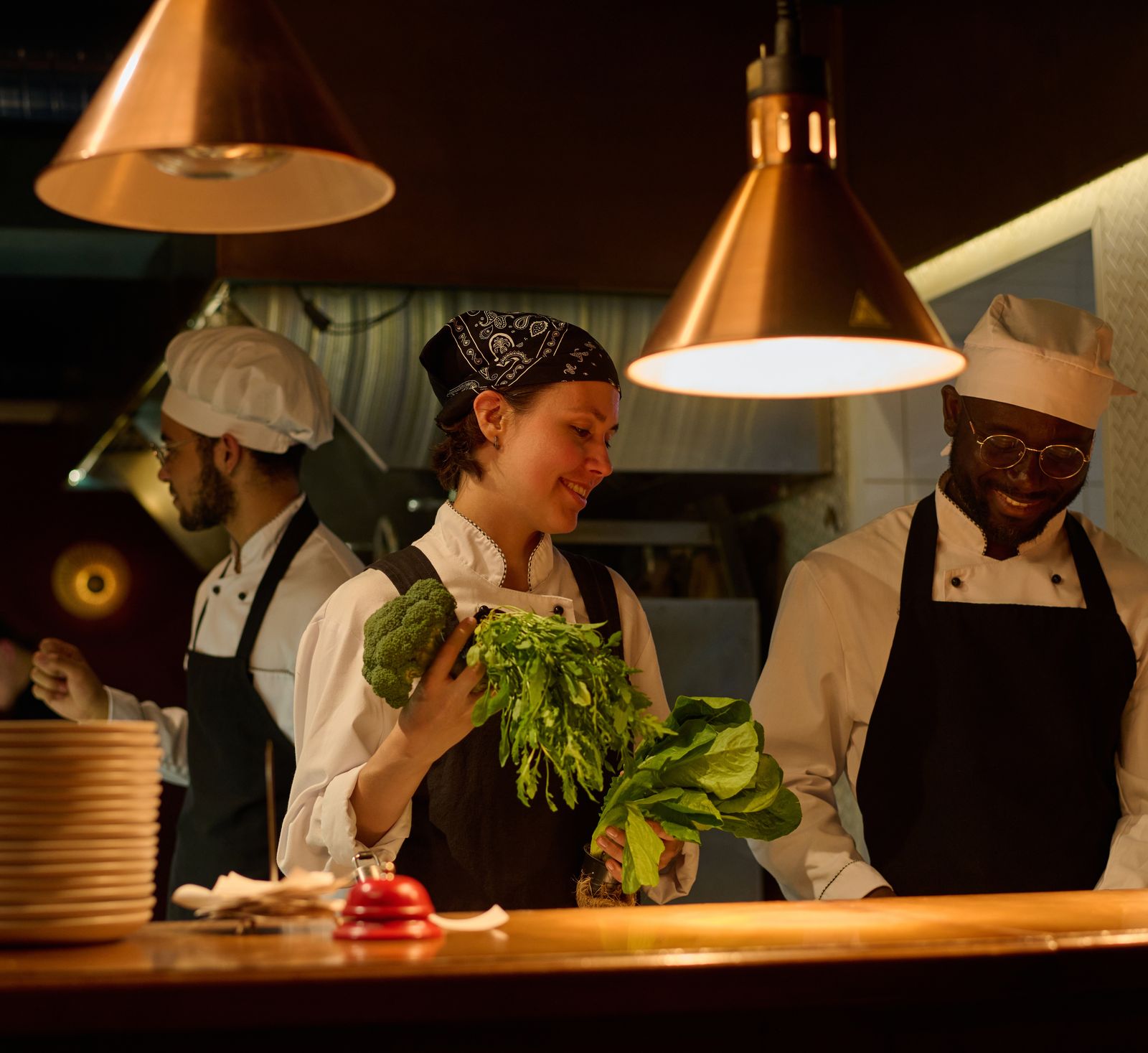 Chefs preparing fresh vegetables in a restaurant kitchen